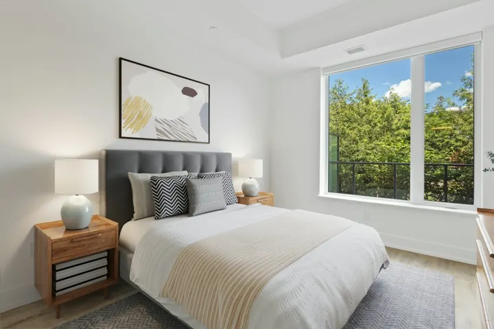 Furnished bedroom with a large window